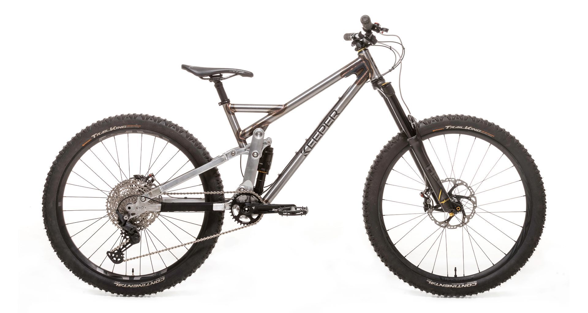 Mountain bike with front suspension, gray frame, black tires, and disc brakes.