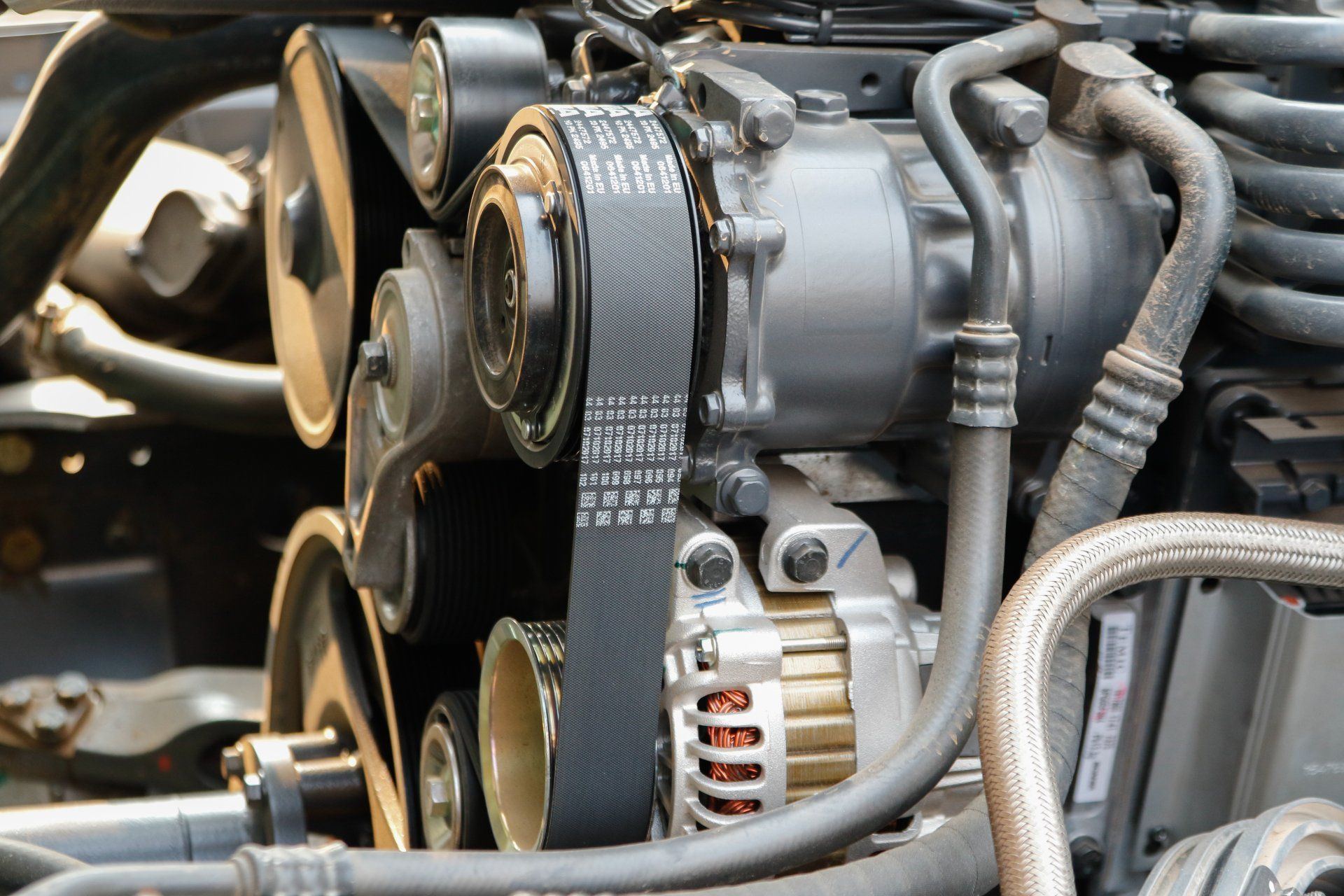 a close up of a car engine with a belt on it
