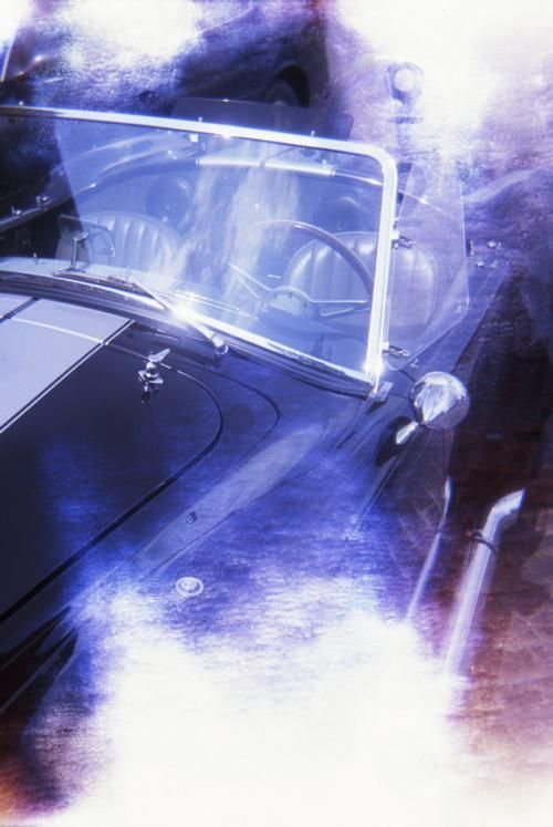 Classic black car with white racing stripe, windshield, and blue-tinted effect.