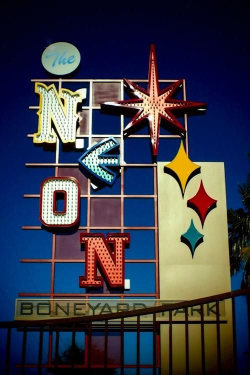 Neon sign in the Boneyard Park. Features a star, arrow, and the words 