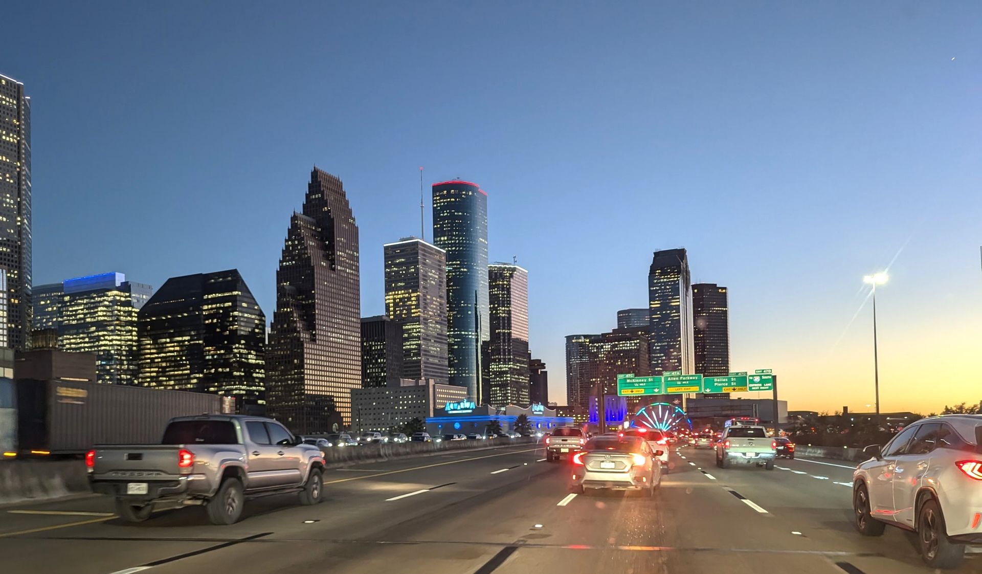 A dining room with a table and chairs and a wooden staircase.