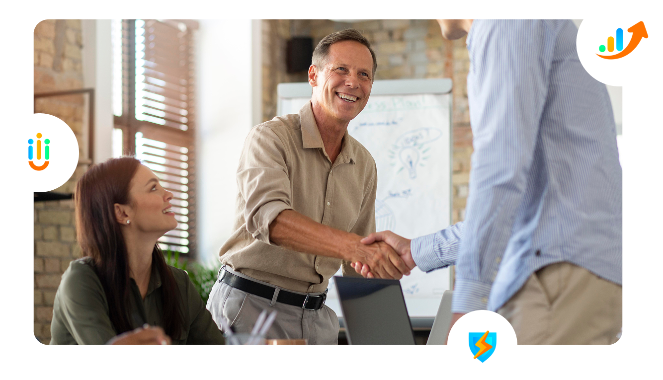 A group of people are shaking hands in an office.