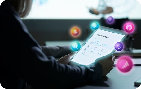 A woman is holding a tablet with a graph on it.