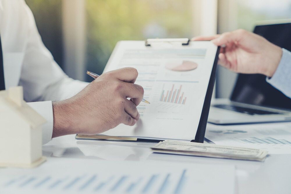 Two People Reviewing Financial Documents at A Desk — SDM Accounting & Taxation Services In Cooroy, QLD