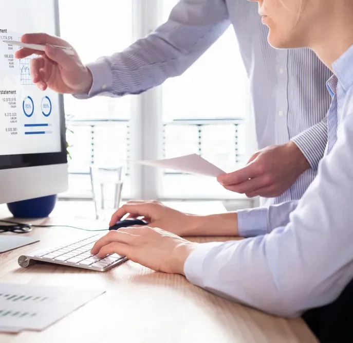 Two People Reviewing Financial Data on A Desktop — SDM Accounting & Taxation Services In Cooroy, QLD
