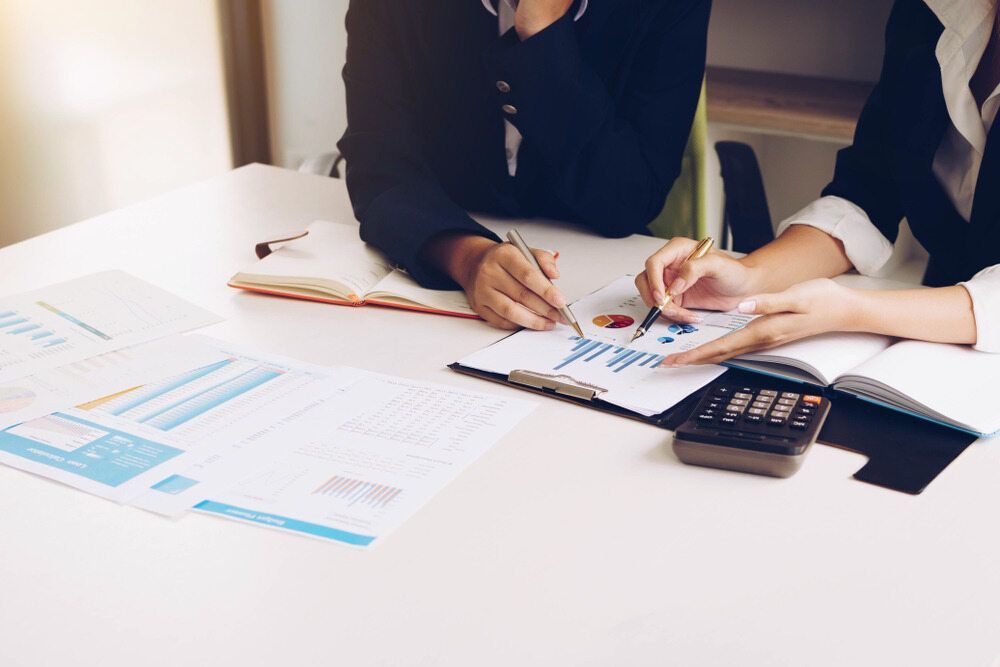 Two People In Business Attire Reviewing Financial Reports — SDM Accounting & Taxation Services In Cooroy, QLD