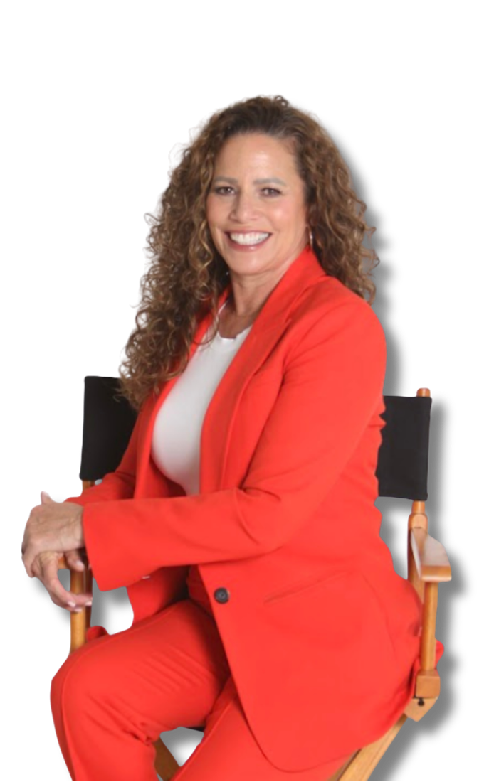 Tina in a black jacket and white skirt is smiling with her arms crossed