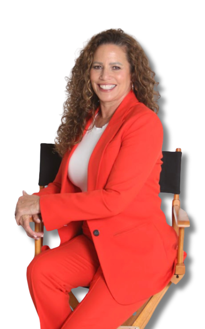 Tina in a black jacket and white skirt is smiling with her arms crossed