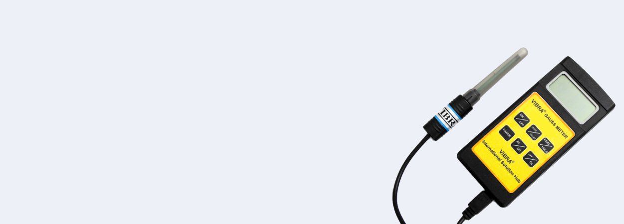 A yellow and black handheld moisture meter with a probe, connected by a black wire.