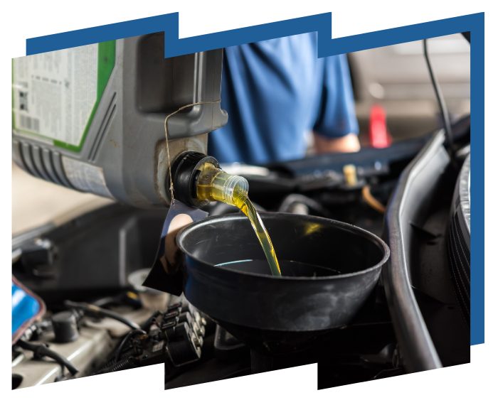 A person is pouring oil into a car engine
