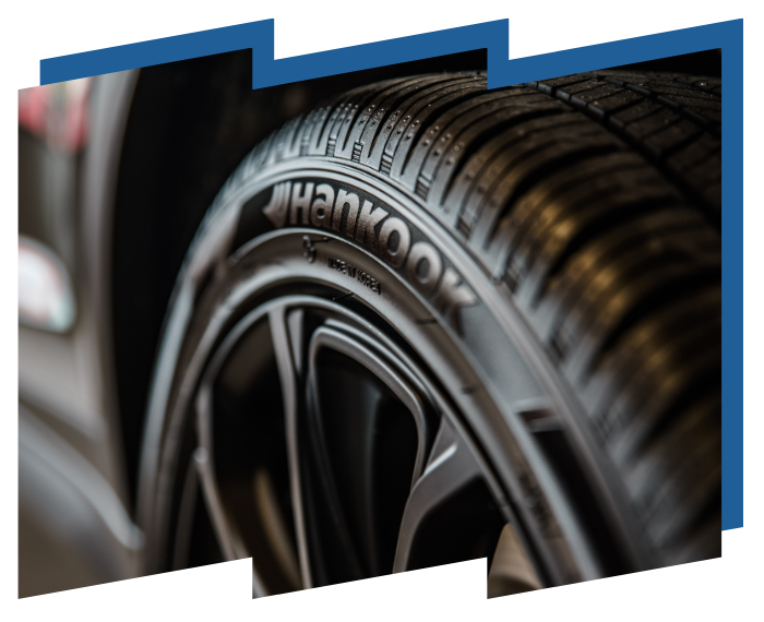 A close up of a hankook tire on a car wheel