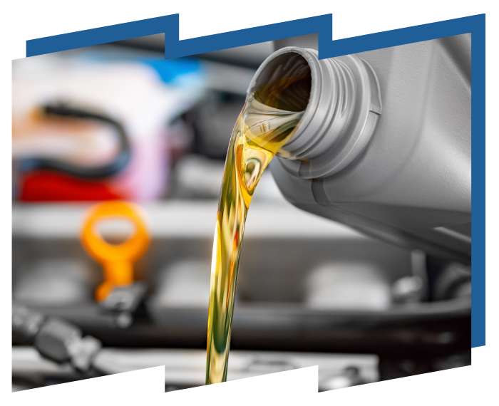 A bottle of oil is being poured into a car engine.