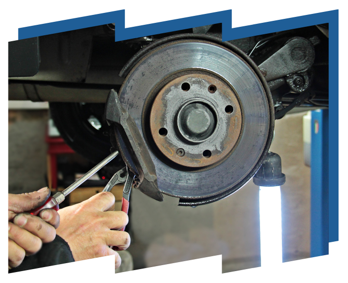 A person is working on a car with a screwdriver and pliers.