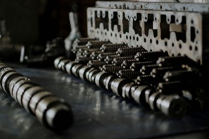 A black and white photo of a bunch of cylinder heads