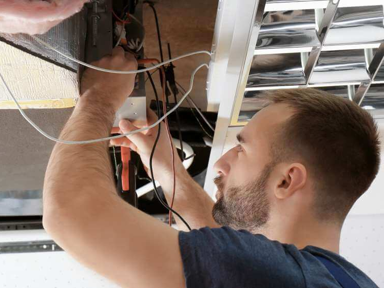 man repairing air vent