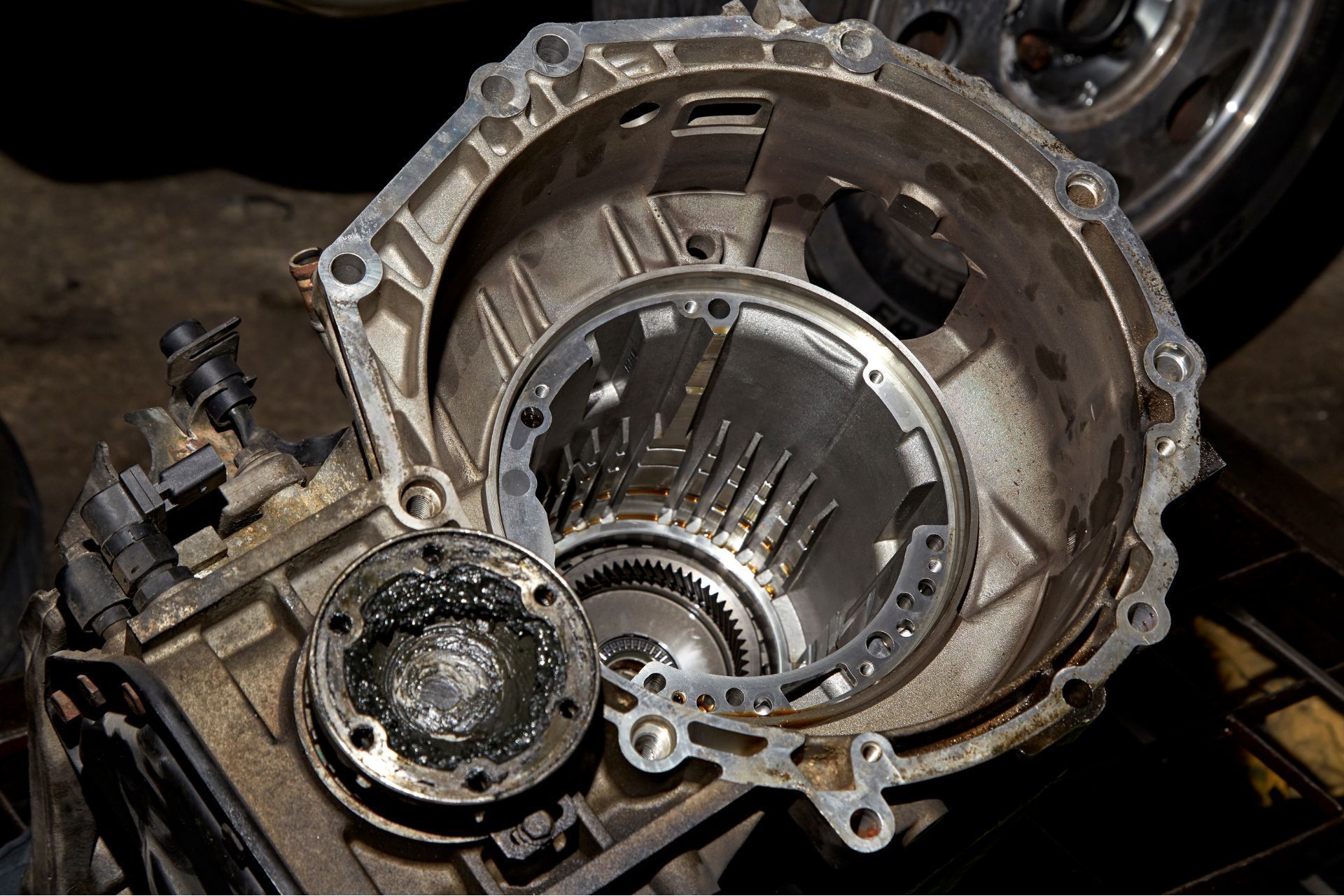 A close up of a car engine with the cover removed.
