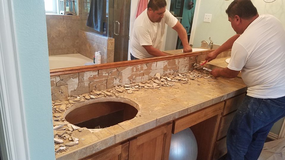 Worker clipping old bathroom tile