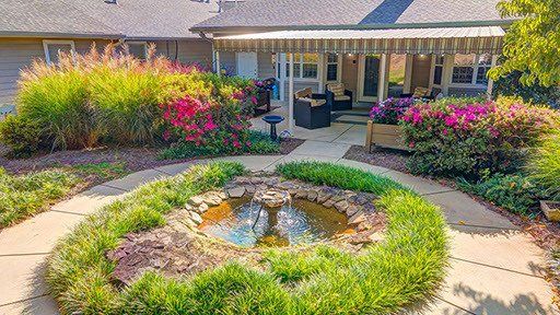 There is a fountain in the middle of the garden.