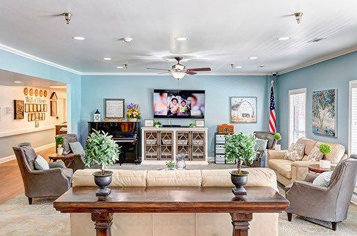 A living room filled with furniture and a television.