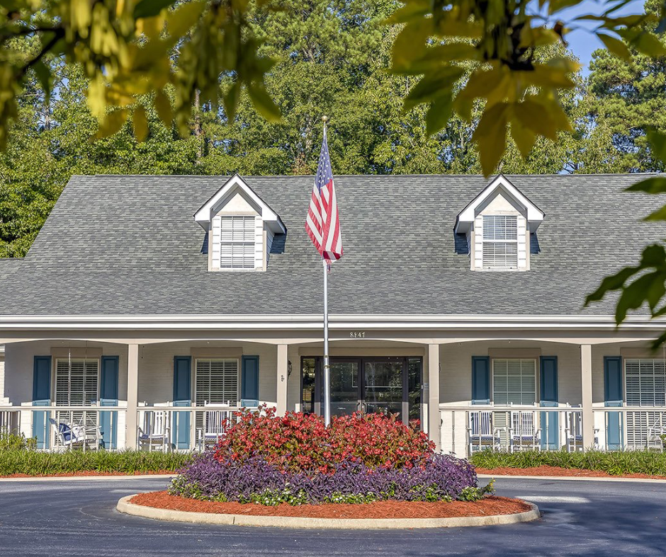 An american flag is flying in front of a house
