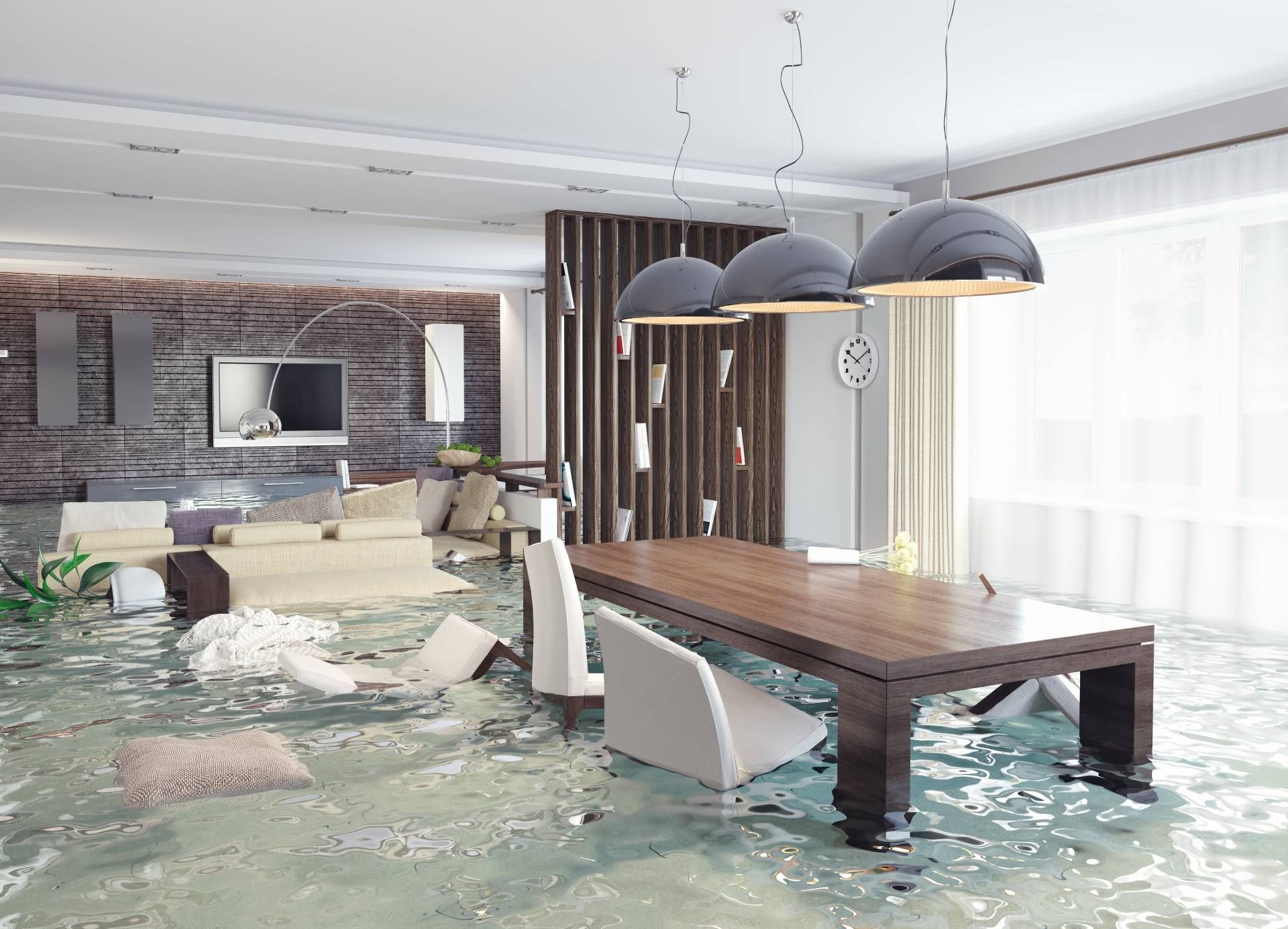 A flooded living room with a table and chairs covered in water.