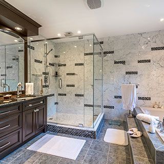 A bathroom with a walk in shower and a bathtub.