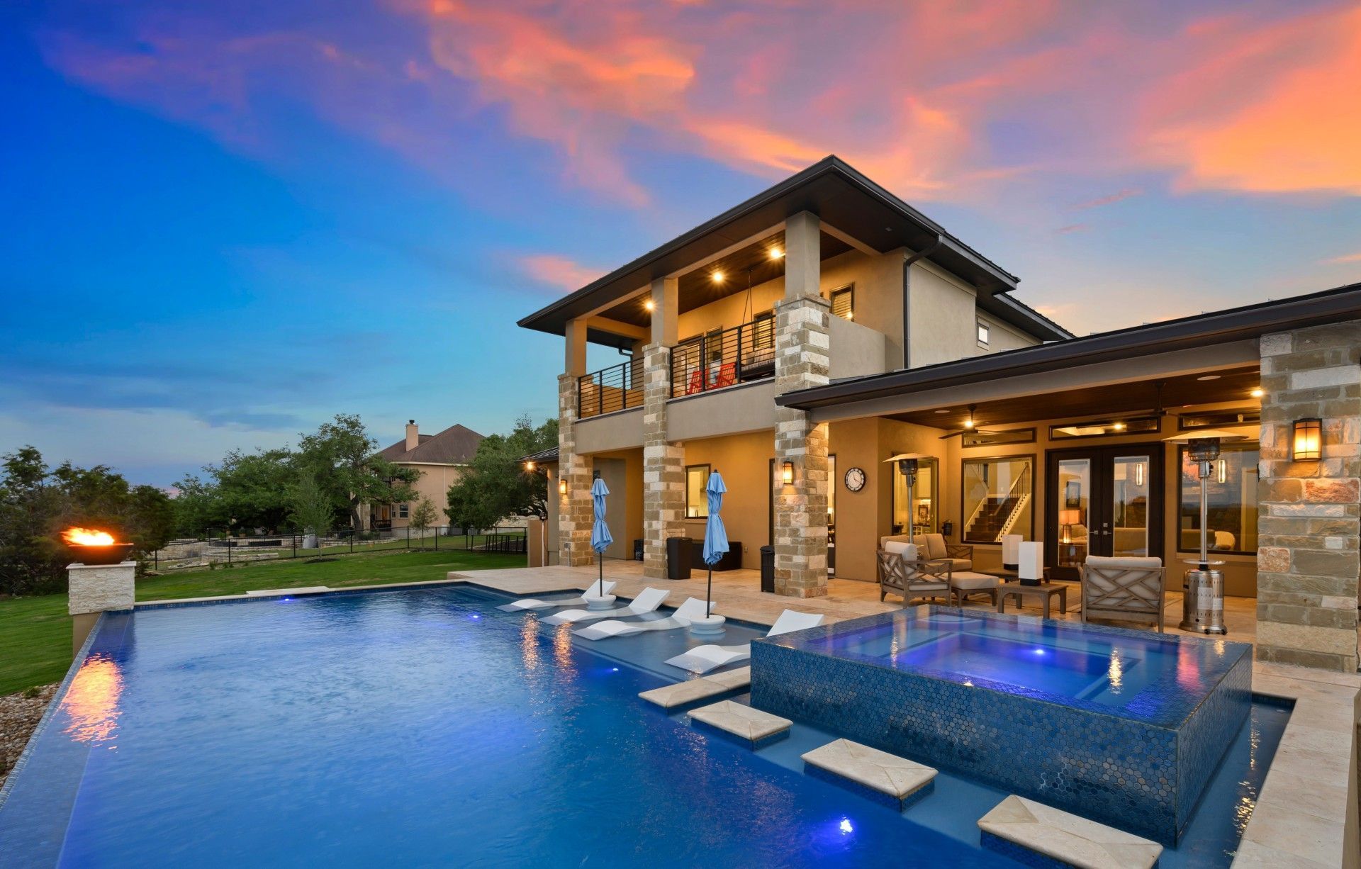 A large house with a swimming pool in front of it