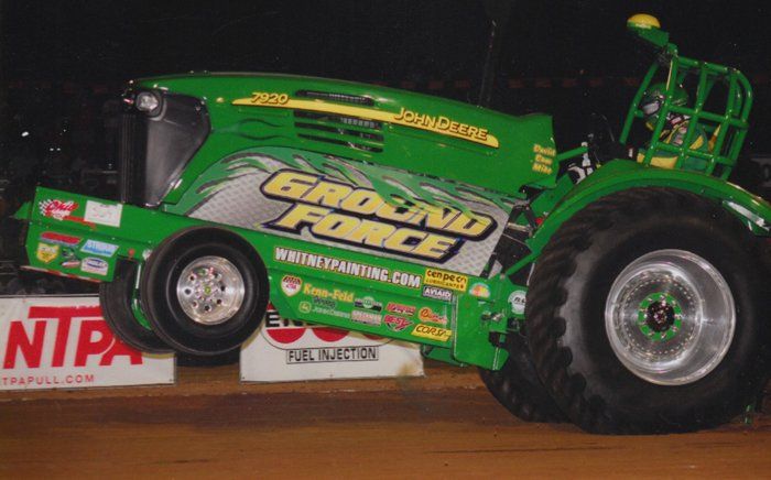 Green John Deere tractor in a tractor pull, 