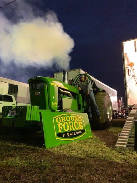 Green tractor with smoke, 