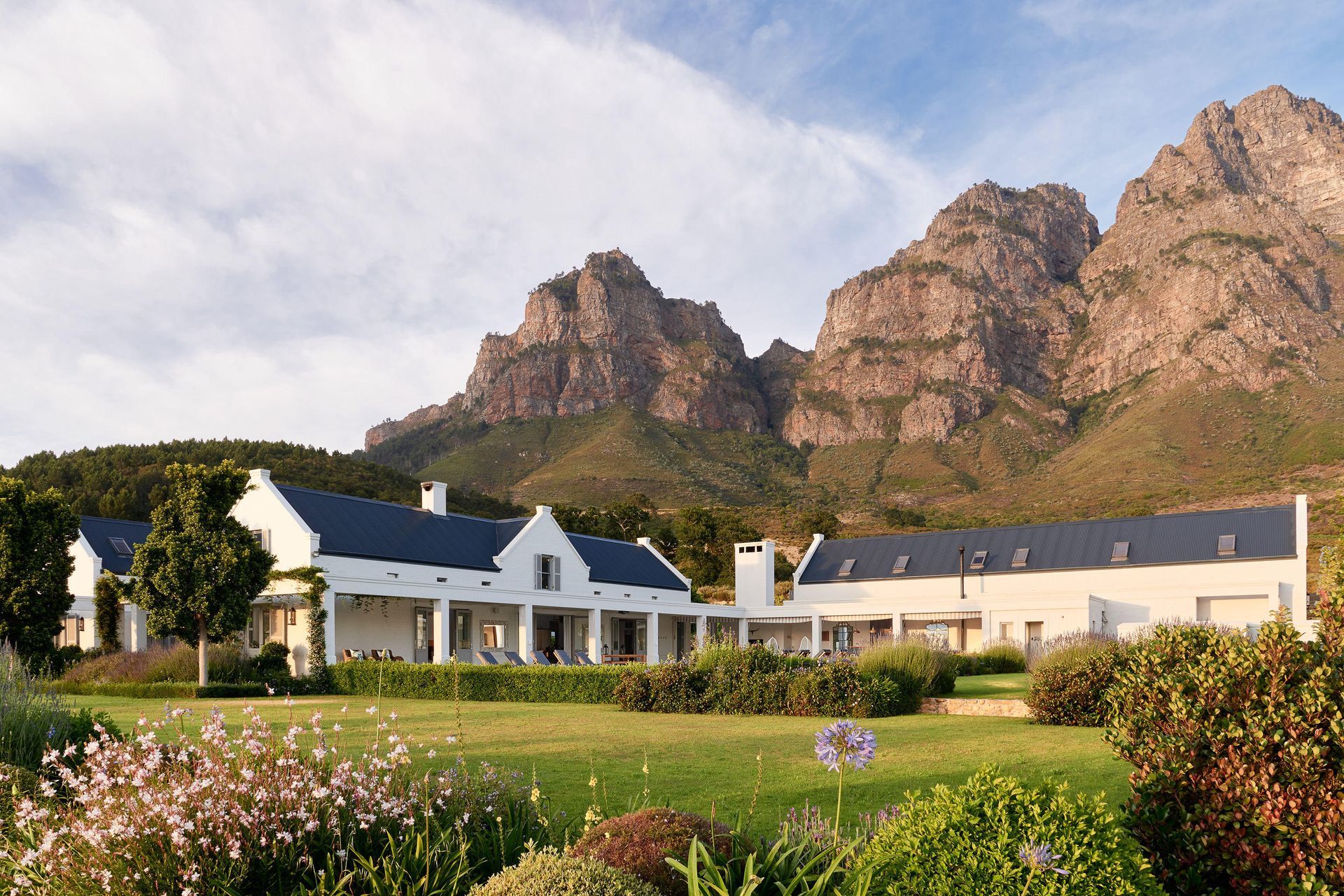 A white house with a mountain in the background