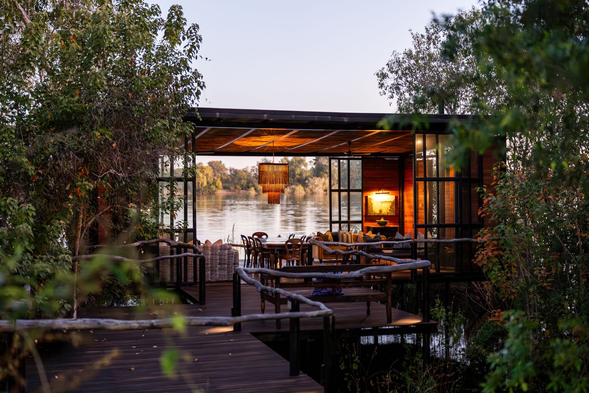 A bedroom with a canopy bed and a view of a river.