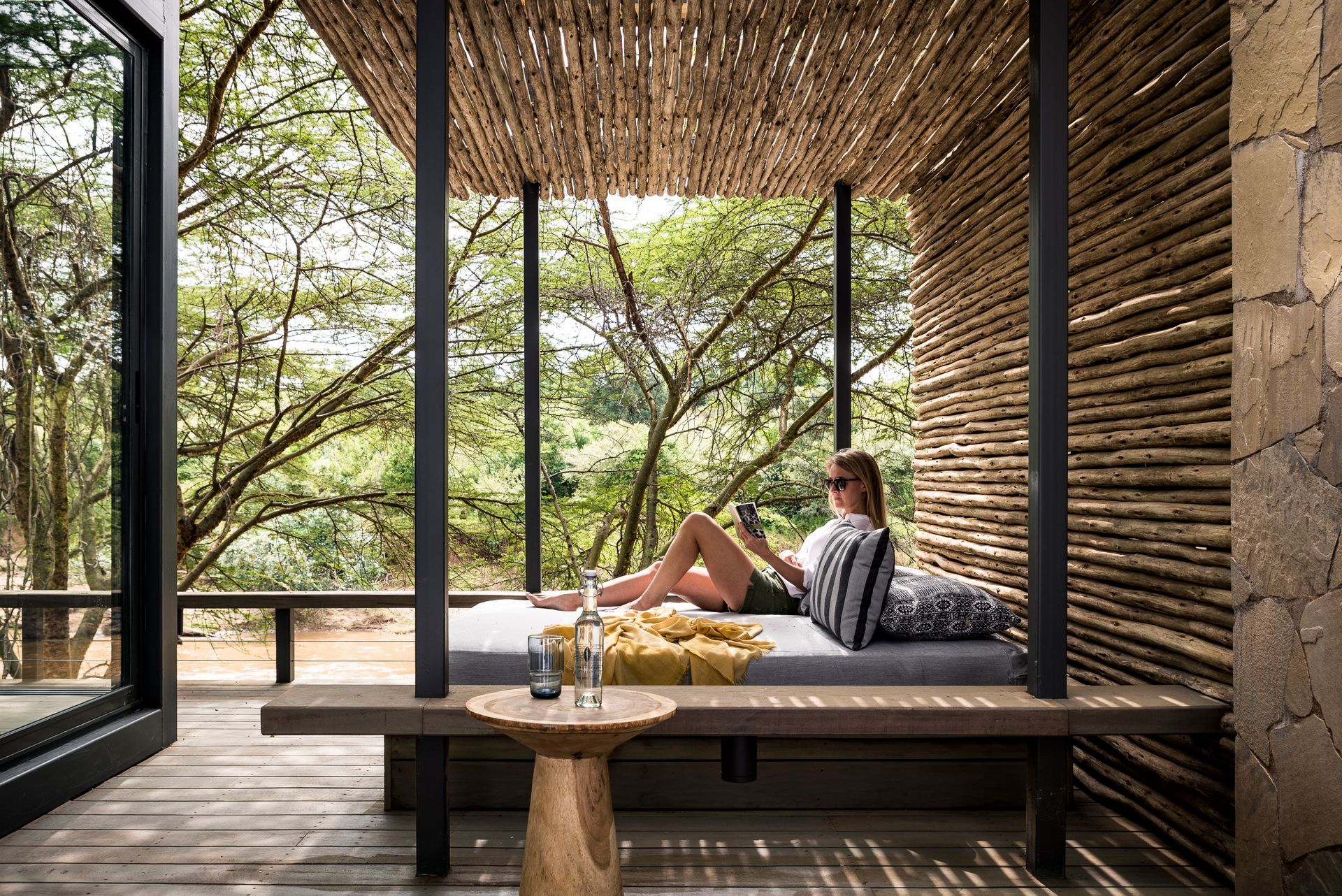 An aerial view of a house on top of a hill surrounded by trees.