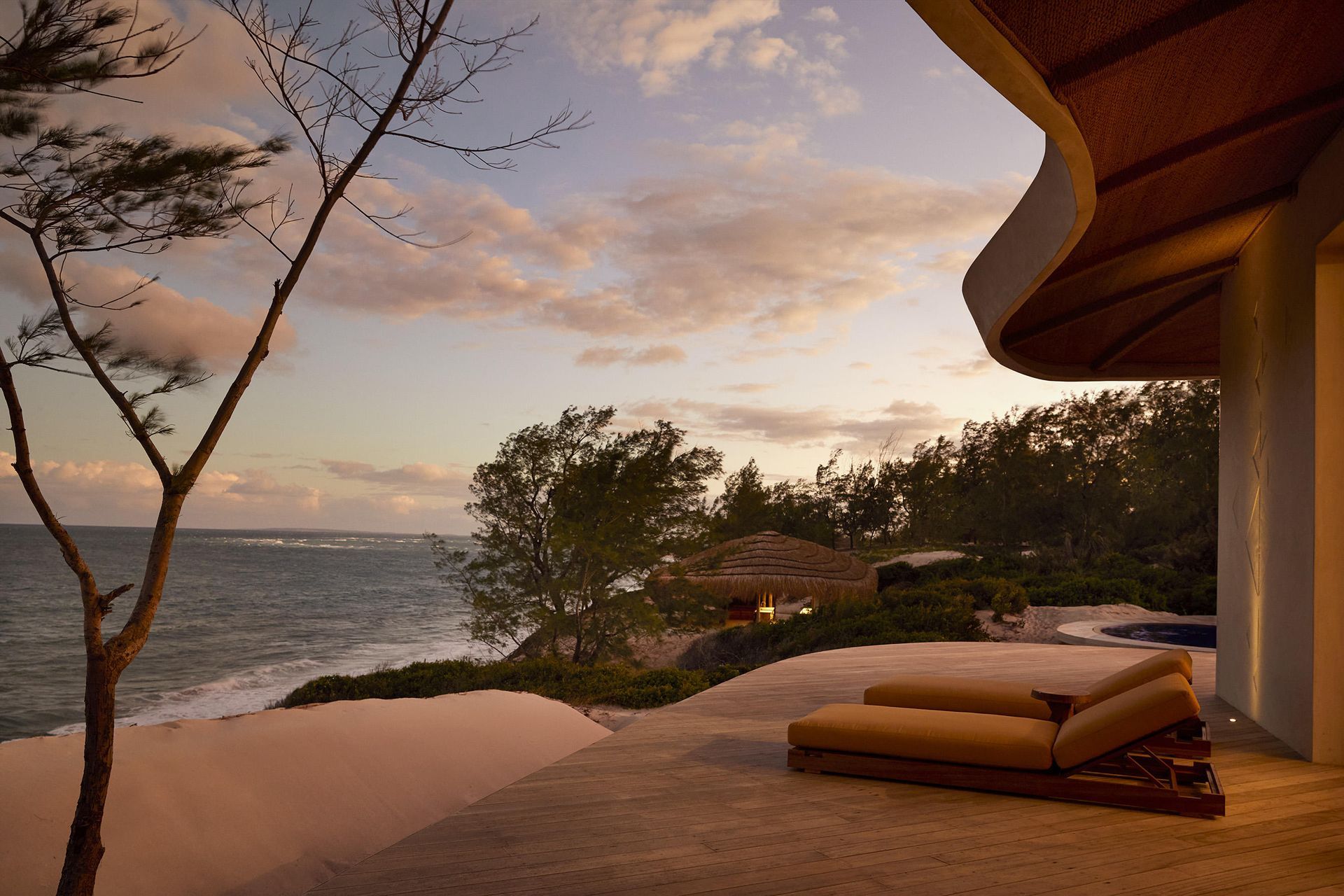 A bedroom with a canopy bed and a view of the ocean.
