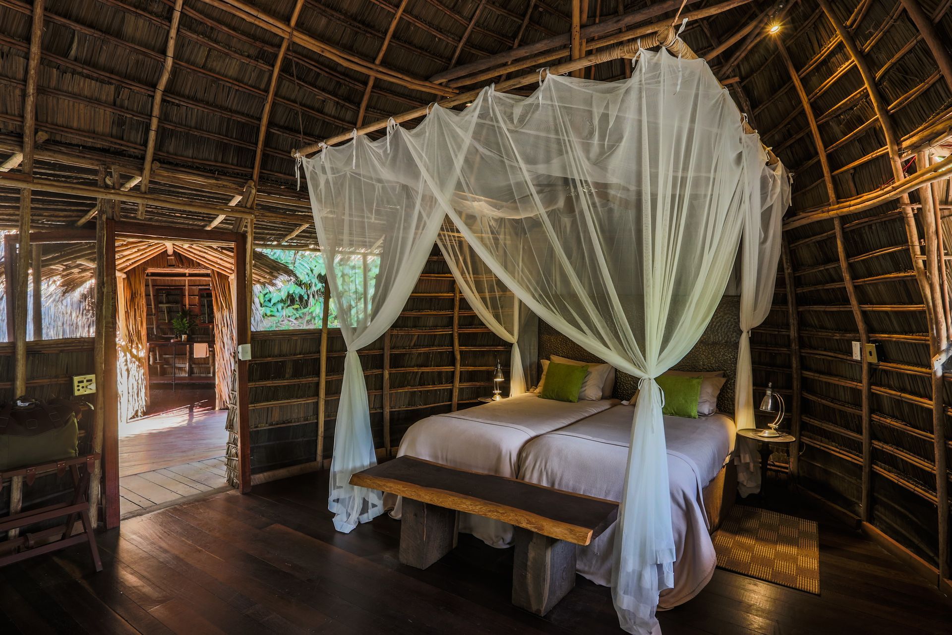 There are two beds in the room with mosquito nets.