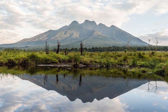 A mountain is reflected in a body of water.