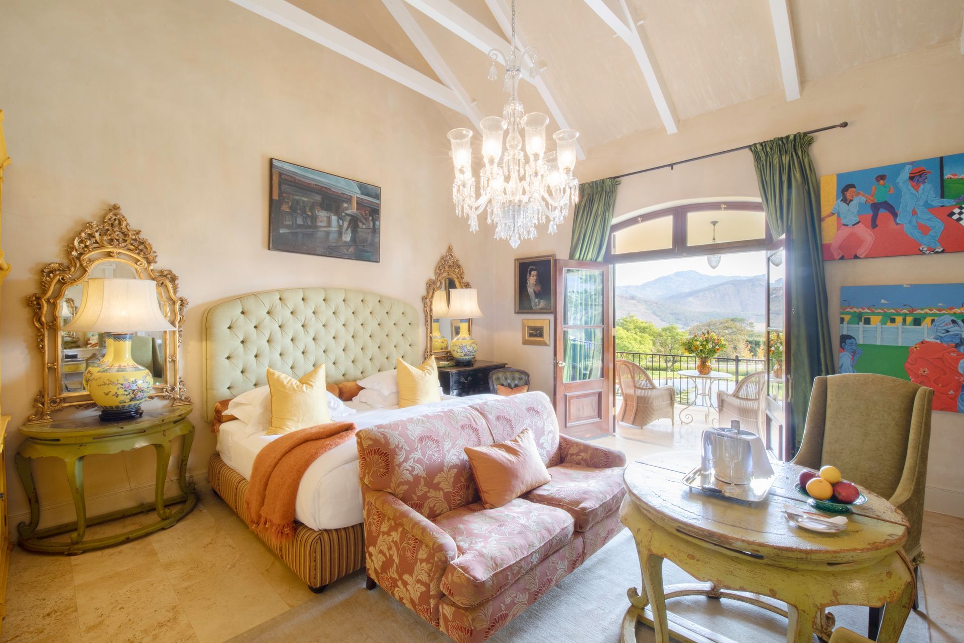 A bedroom with a large bed a couch and a table