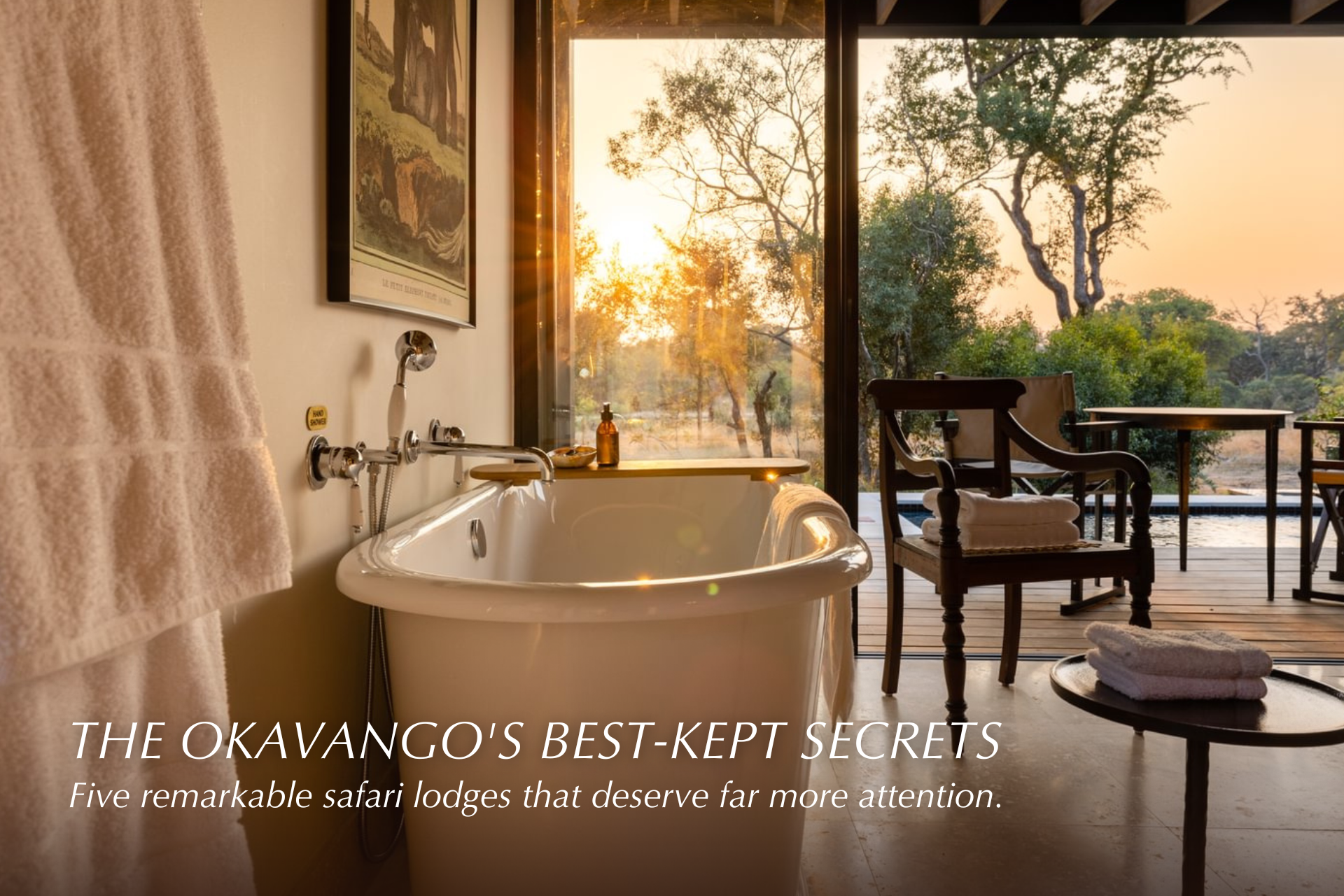 Luxury bathroom with freestanding tub overlooking a African sunset terrace and trees