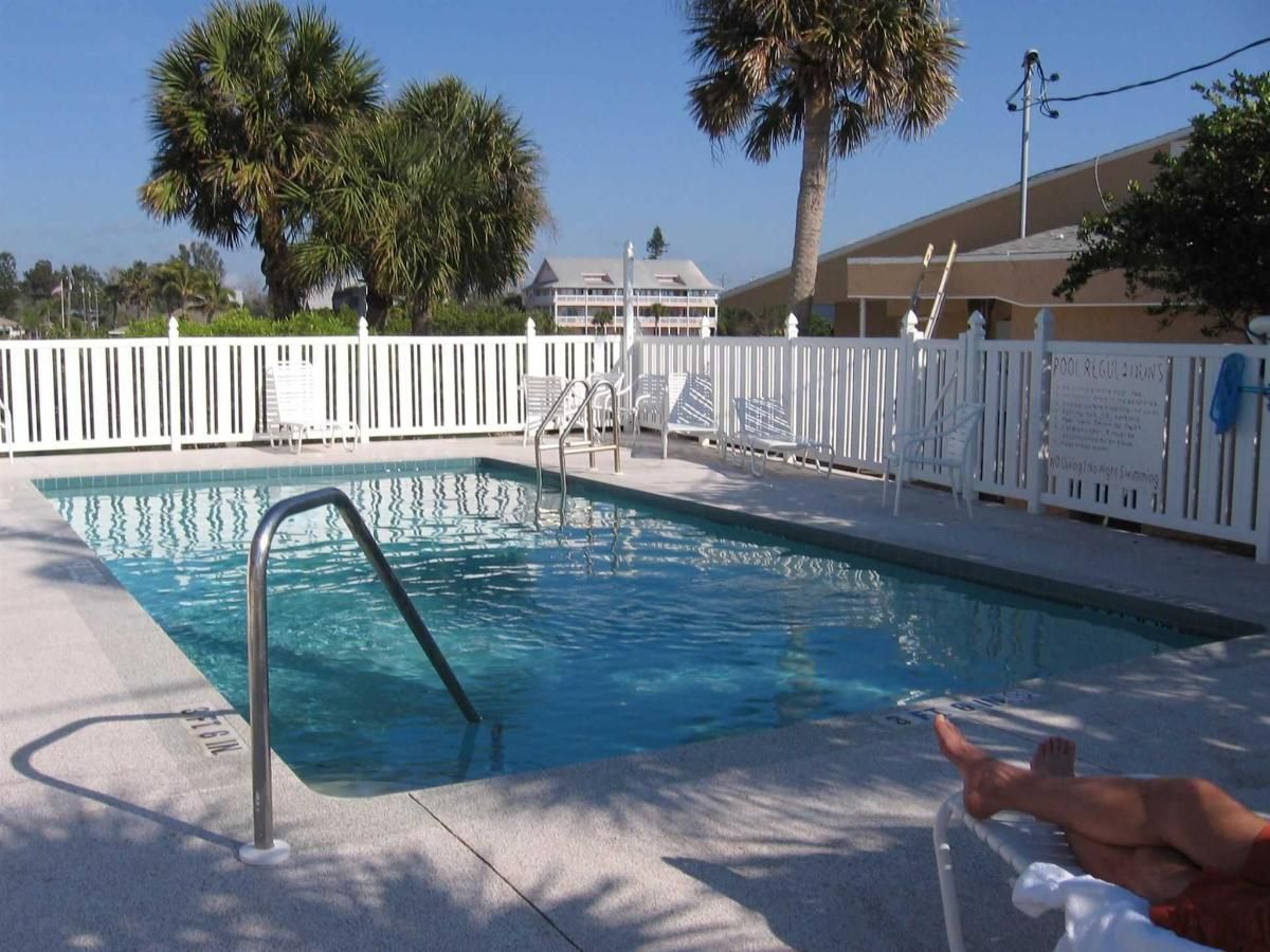 A swimming pool with a white fence around it