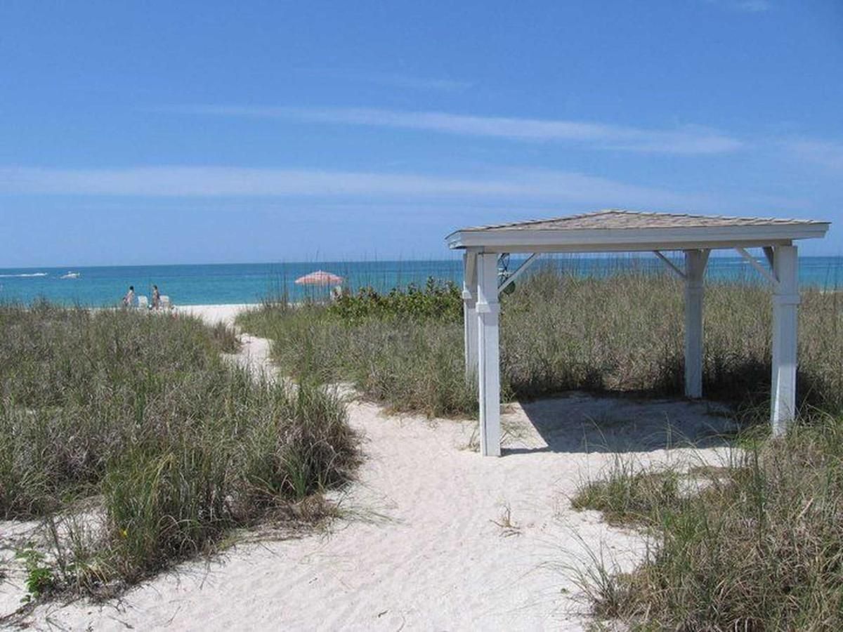 A path leading to the beach with a gazebo in the middle