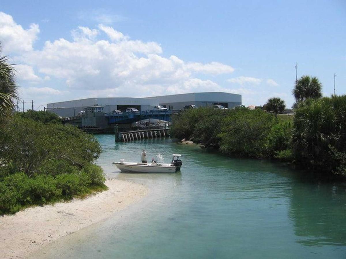 A boat is floating on the water near a beach