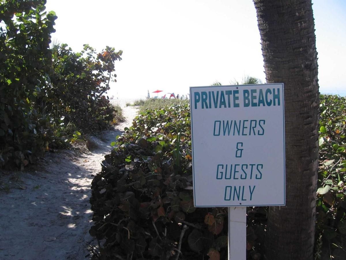 A sign that says private beach owners and guests only