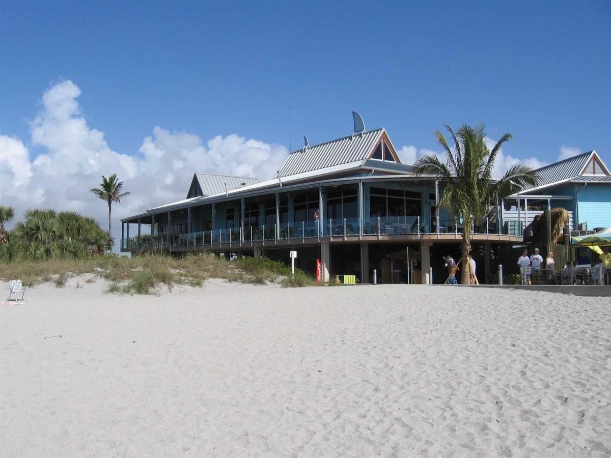 A large building on the beach with a sign that says no dogs