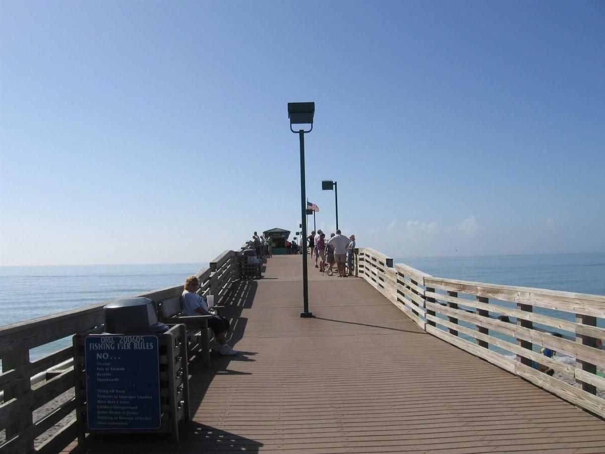 A pier with a sign that says ' fishing ' on it