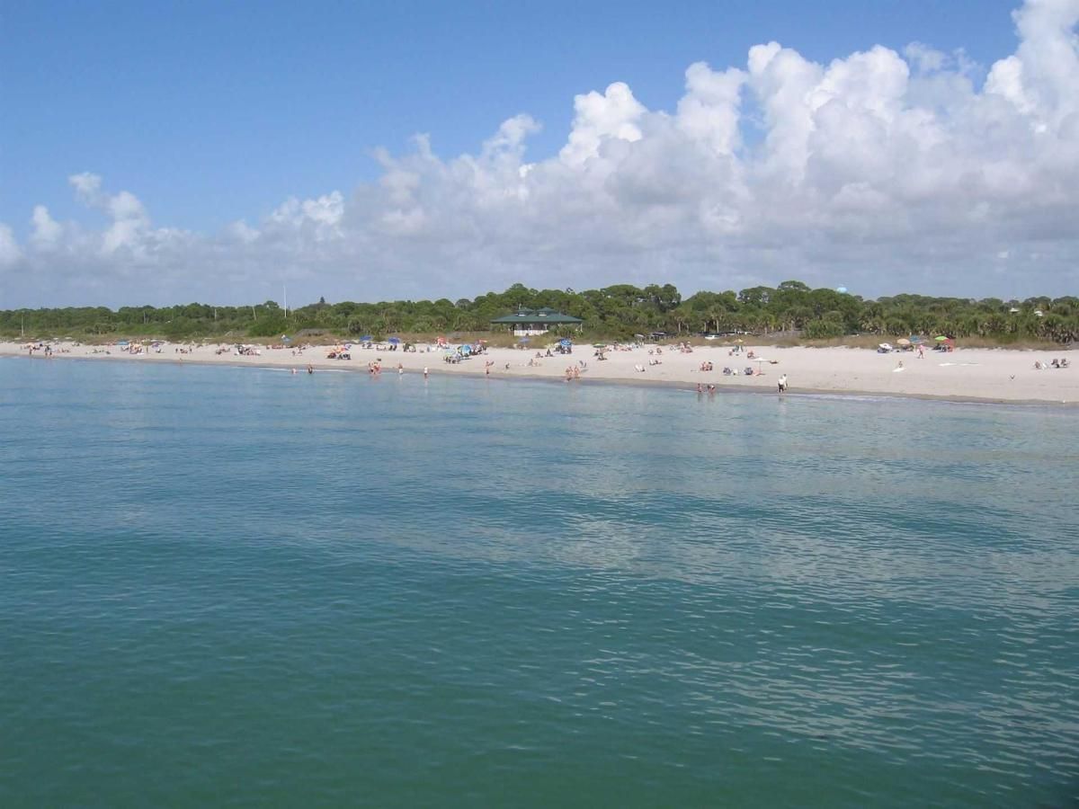 A large body of water with a beach in the background