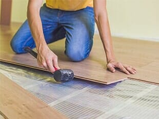 Installation — Man Installing New Wooden Laminate Flooring in Staten Island, NY