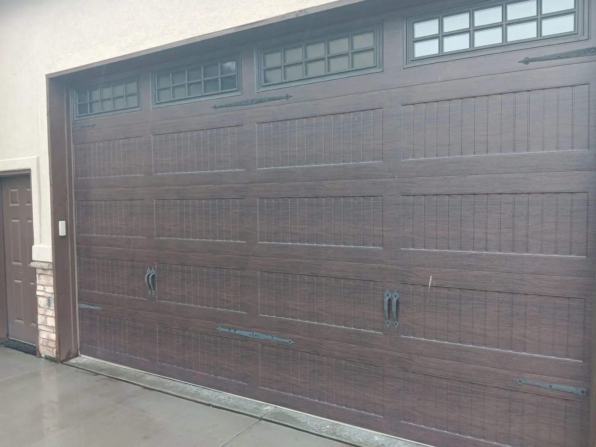 A large brown garage door with a lot of windows on it.