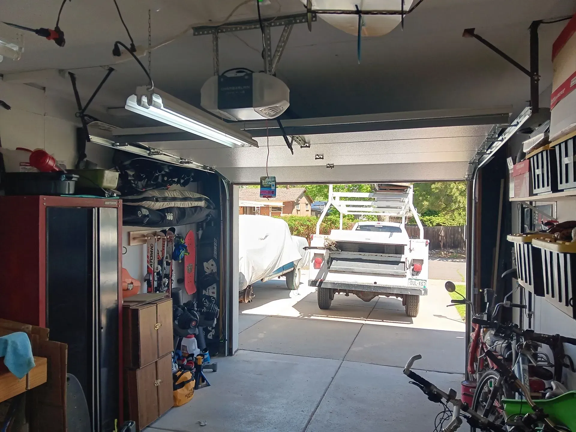 A truck is parked in a garage with the door open