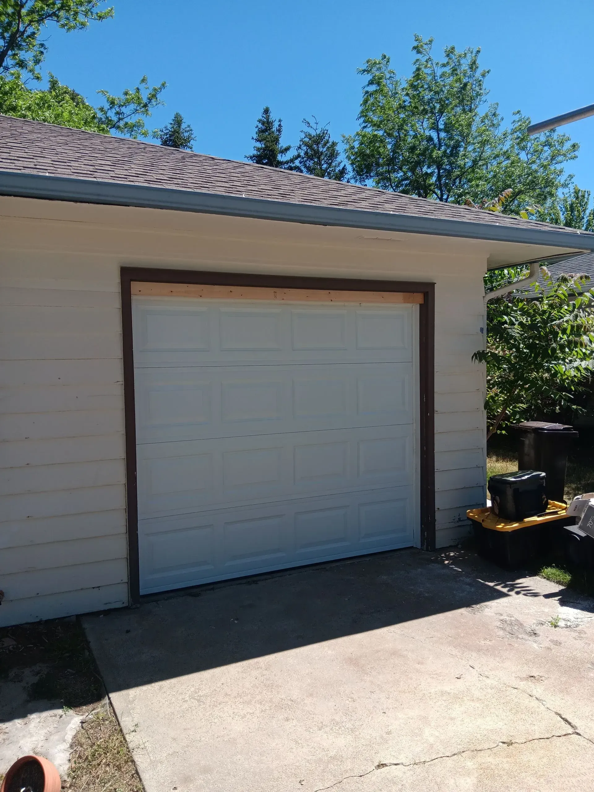 The front of a house with a white garage door