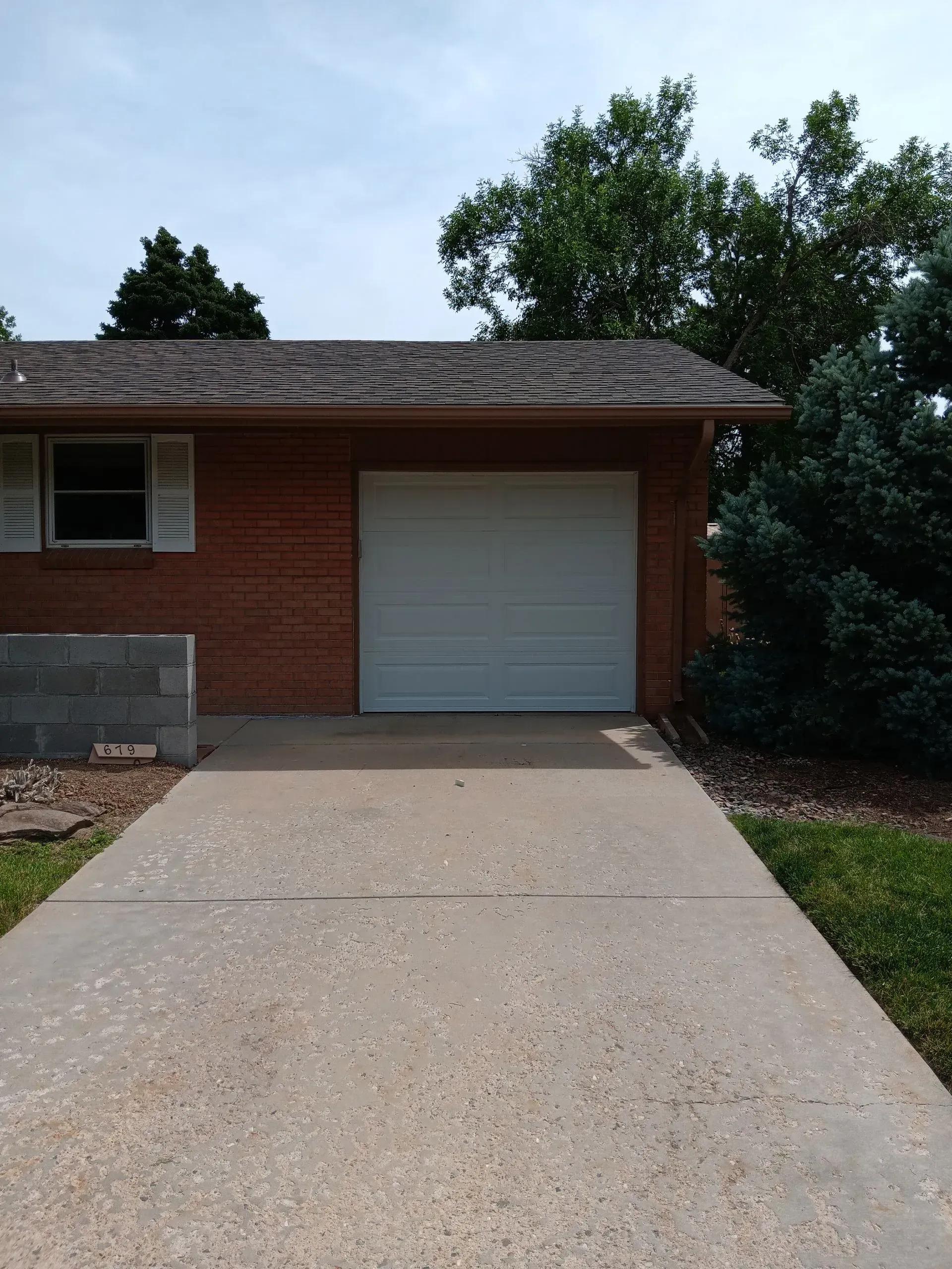 A brick house with a white garage door