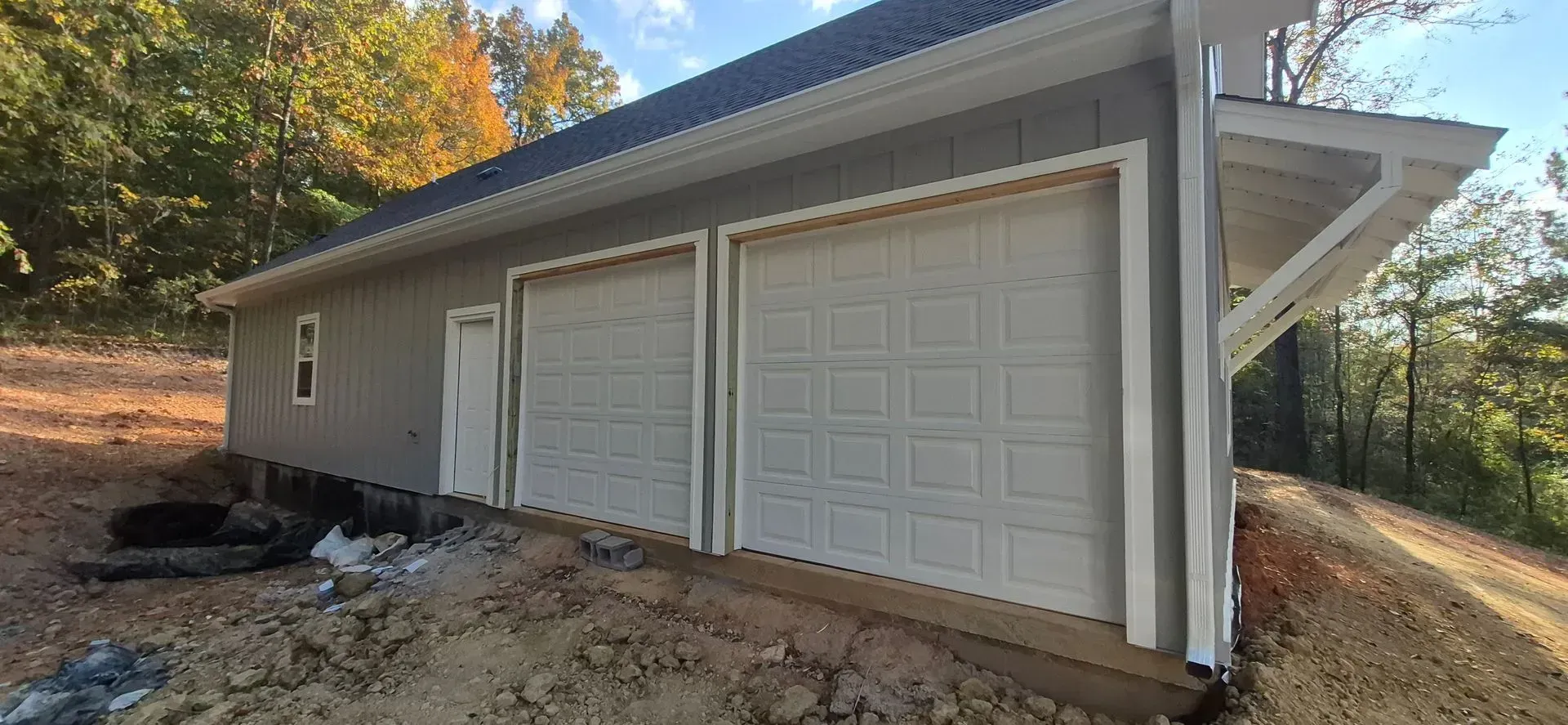 The front of a house with a white garage door